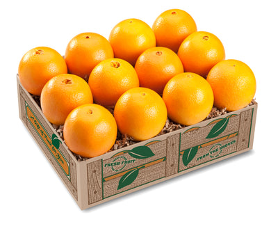 A box of fresh navel oranges displayed with several oranges visible outside the box, highlighting their color and condition.
