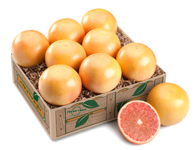 A box of fresh Ruby Red Grapefruits with one grapefruit cut open to show the inside.